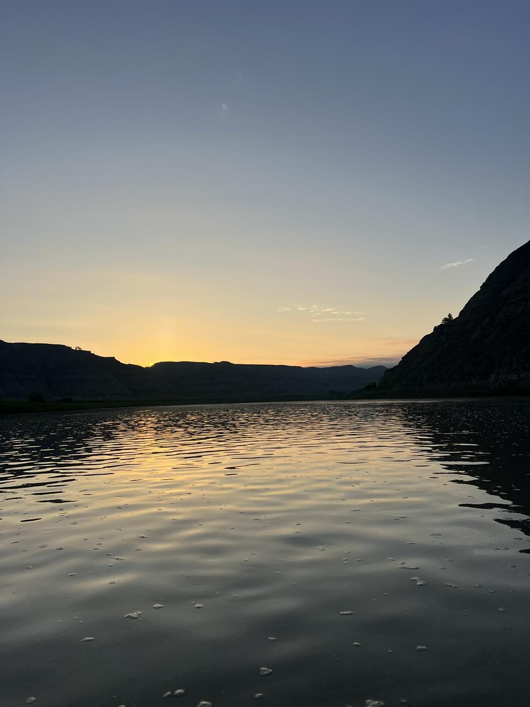 Sunset over the Missouri River Breaks, calm water reflecting the last light